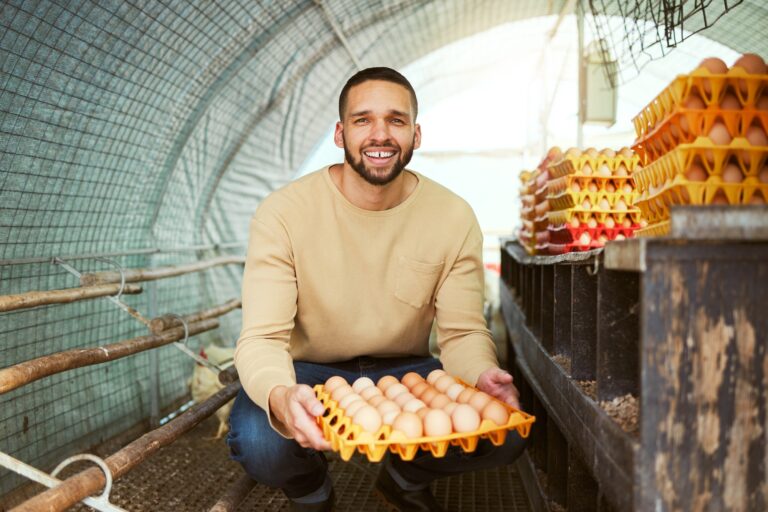 Portrait, chicken farmer and man with eggs at farm in barn or chicken coop. Agro sustainability, fo